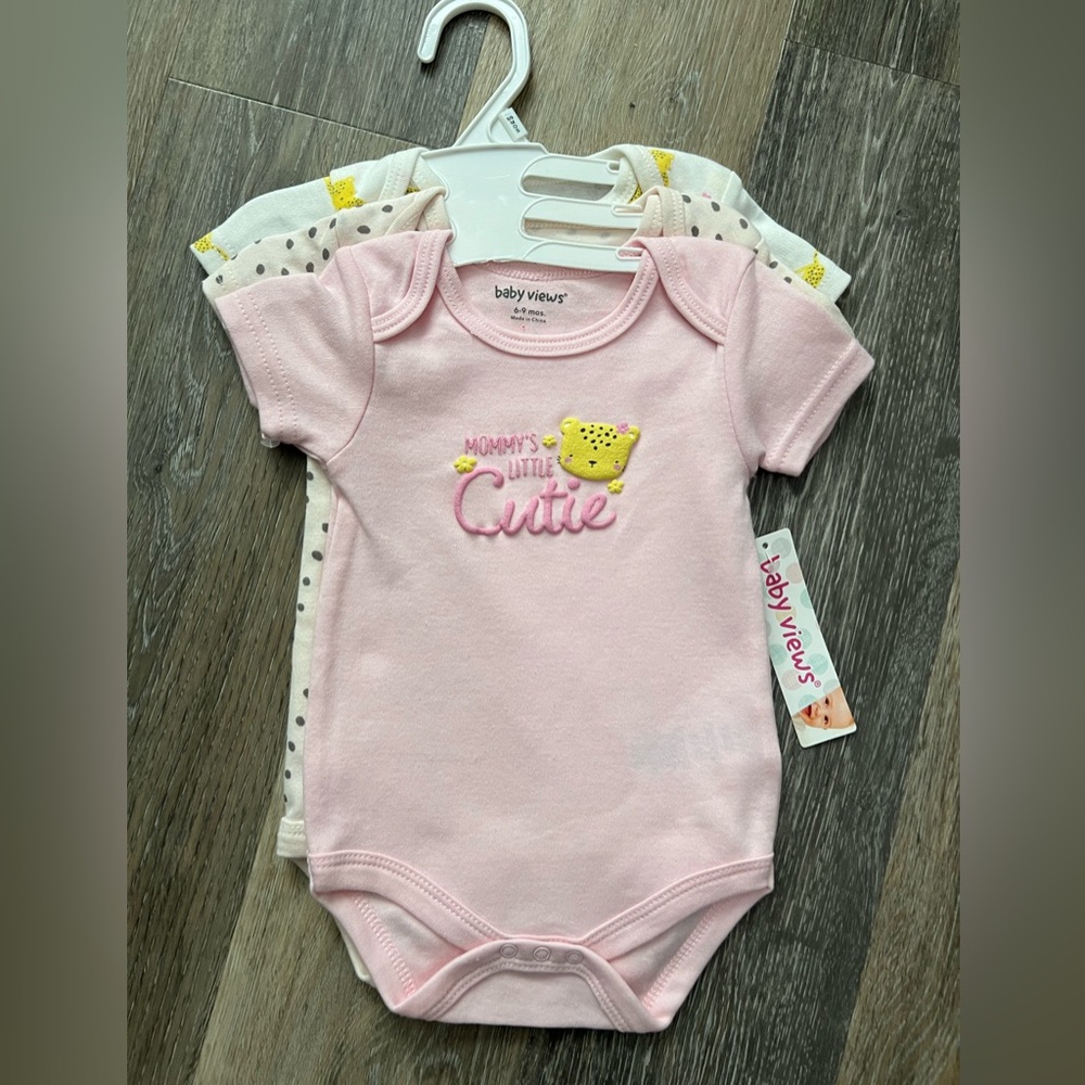 This is a set of three baby onesies by Baby Views, in size 6-9 months